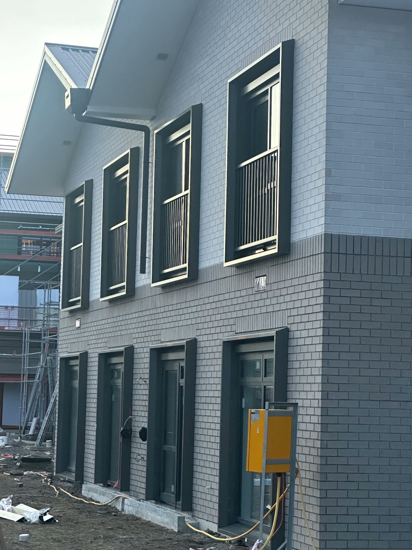 Two-storey brick and timber build with newly installed windows and doors